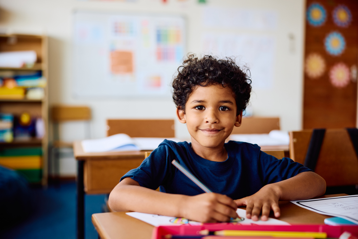School-aged child showing signs of hearing loss in the classroom